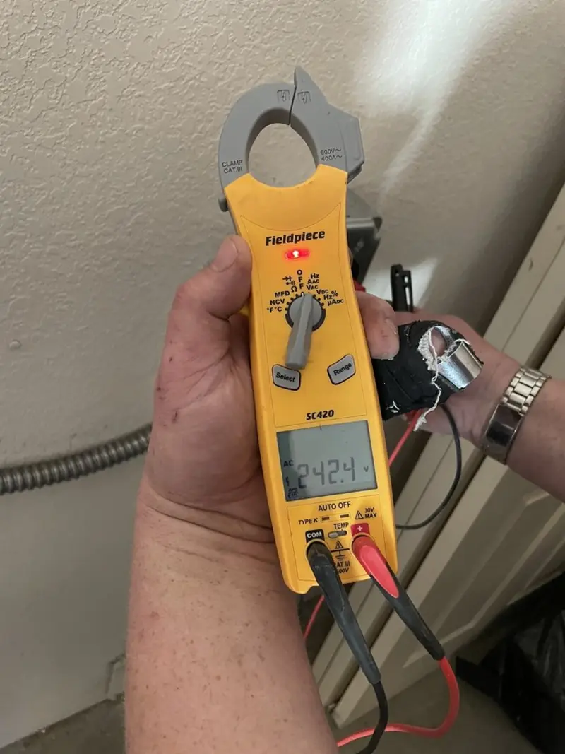 Voltage testing with clamp meter during Electrical Installation Services in Town and Country